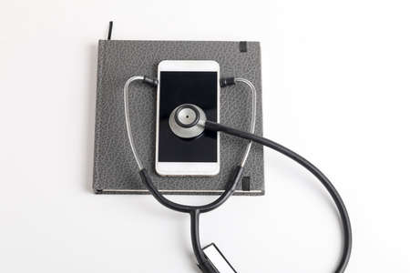 Smartphone and stethoscope on whiteの写真素材