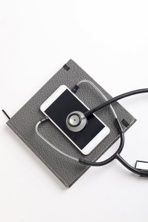 Smartphone and stethoscope on whiteの写真素材