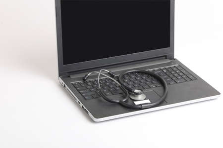Workplace of doctor with laptop and stethoscope and smartphone on white table top view shot.の写真素材