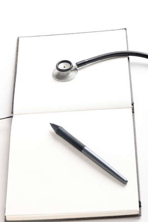 Black stethoscope lying on the diary, medicine.の写真素材