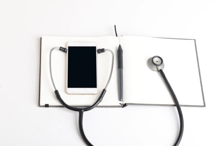 Black stethoscope lying on the diary, medicine.の写真素材