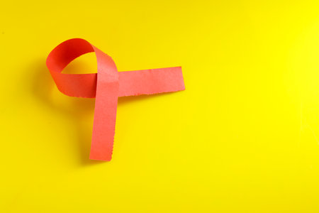 Red ribbon as symbol of aids awareness isolated on whiteの写真素材