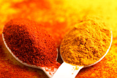 Turmeric and chili powder in spoonの写真素材