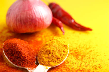 Turmeric and chili powder in spoonの写真素材