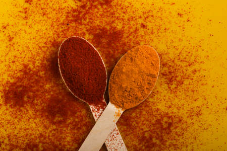 Turmeric and chili powder in spoonの写真素材