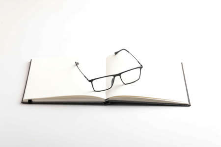 Spectacles or eyeglasses and diary on whiteの写真素材