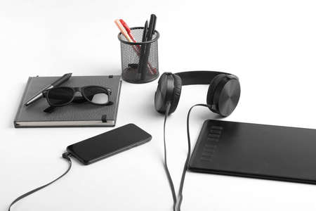 Work from home concept. smartphone, diary and earphone on whiteの写真素材
