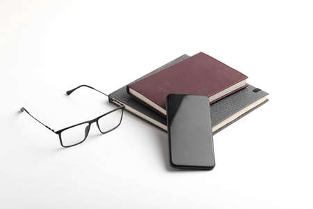 Smartphone, diary and spectacles on whiteの写真素材