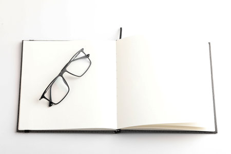 Spectacles or eyeglasses and diary on whiteの写真素材