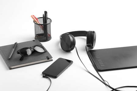 Work from home concept. smartphone, diary and earphone on whiteの写真素材