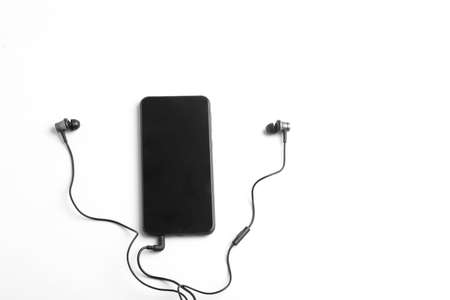 Smartphone and earphone or headphone on whiteの写真素材