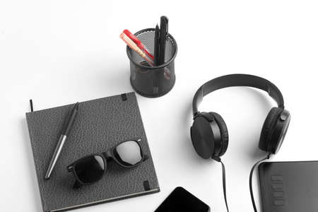 Work from home concept. smartphone, diary and earphone on whiteの写真素材