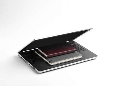 Modern workspace with laptop keyboard, notebook on whiteの写真素材