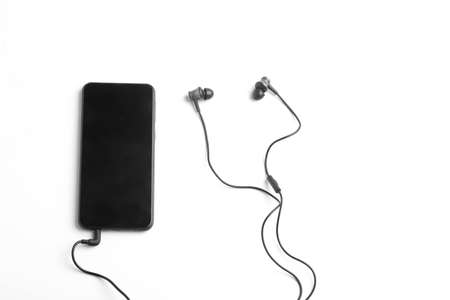 Smartphone and earphone or headphone on whiteの写真素材