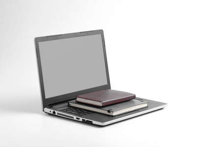 Modern workspace with laptop keyboard, notebook on whiteの写真素材