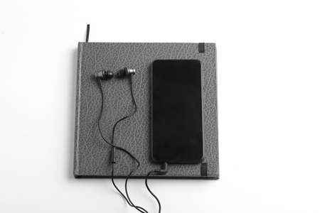 Smartphone,diary,earphone on whiteの写真素材