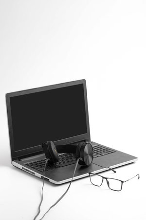 Work from home concept. Laptop and earphone on whiteの写真素材