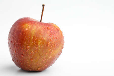 Fresh red apple with water drops isolated on whiteの写真素材