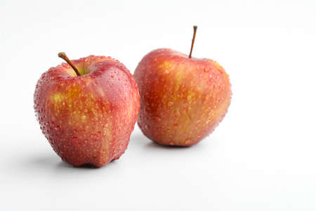 Fresh red apple with water drops isolated on whiteの写真素材