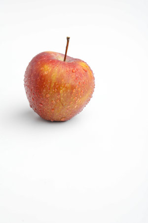 Fresh red apple with water drops isolated on whiteの写真素材