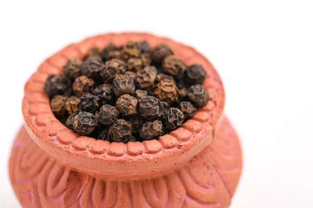 Black pepper in clay bowl.の写真素材
