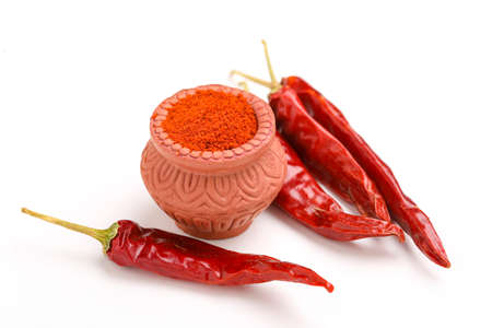 Red chilli powder in a bowl with dry red chilliの写真素材