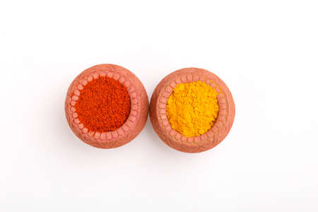 Red chili powder and turmeric powder in bowlの写真素材