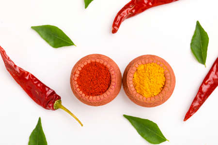 Red chili powder and turmeric powder in bowlの写真素材