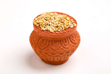 sesame seed in clay bowl over white background.の写真素材