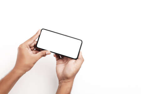 Hand holding a smartphone on a white background.の写真素材