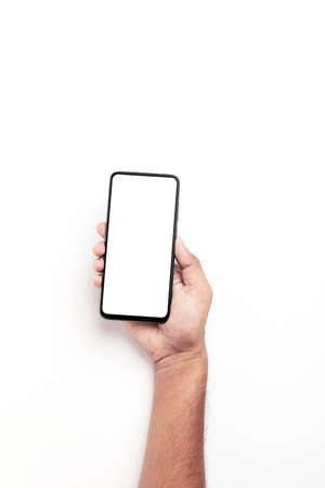 Hand holding a smartphone on a white background.の写真素材