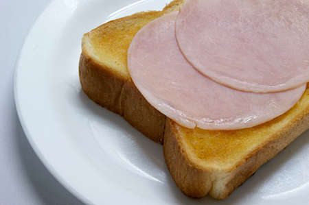 Painted plenty of butter on the bread, topped with hamの写真素材