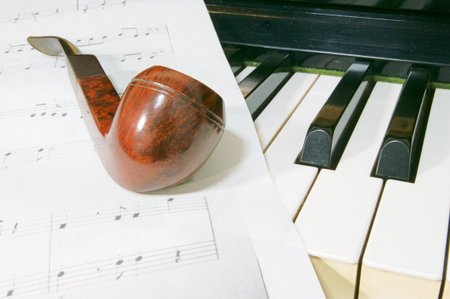 Wooden pipe and sheet music and pianoの写真素材