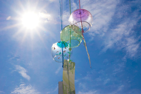 Summer sun and the cool sounds of wind chimesの写真素材