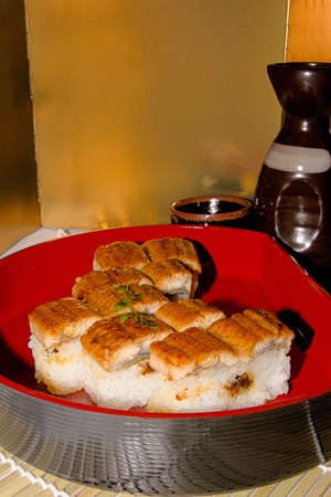 This sushi is made by pressing the rice and eel in the wooden frame.の写真素材
