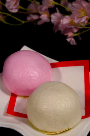 Red and white buns and cherry blossoms to celebrate in Japanの写真素材
