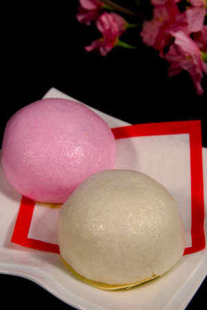 Red and white buns and cherry blossoms to celebrate in Japanの写真素材