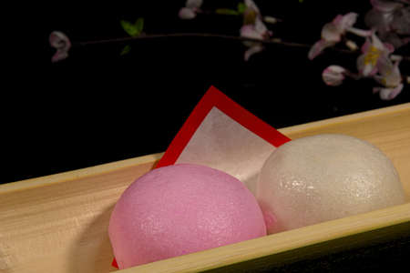Red and white buns and cherry blossoms to celebrate in Japanの写真素材