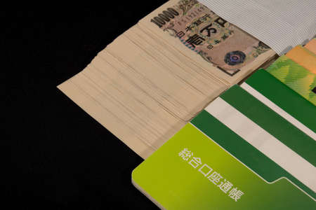 Savings passbooks and cashの写真素材