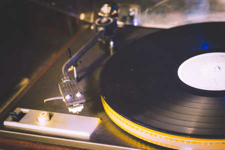 Close up at vintage gramophone. playing old song,Vintage record player with vinyl discの写真素材