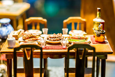 close up Miniature clay figurine Thailand's floating market,Miniature boat carrying tropical fruit on wood backgroundの写真素材