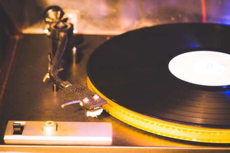 Close up at vintage gramophone. playing old song,Vintage record player with vinyl discの写真素材