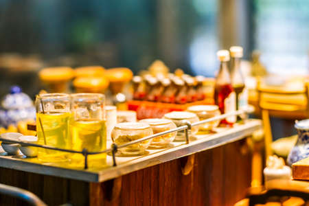 close up Miniature clay figurine Thailand's floating market,Miniature boat carrying tropical fruit on wood backgroundの写真素材
