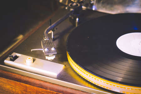 Close up at vintage gramophone. playing old song,Vintage record player with vinyl discの写真素材
