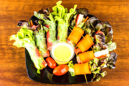 Close up of fresh salad of lettuce, cucumber and tomato on plate for healthy eating.
Fresh vegetable salad in Black plate  on wood table. Salad for healthy. Fresh raw vegetables salad background.の写真素材