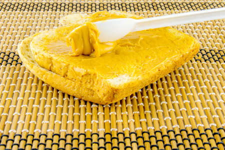 preparing breakfast toast with peanut butter sandwich.の写真素材