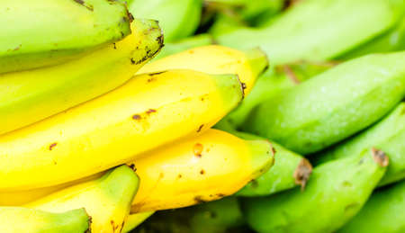 Fresh bananas on wooden background in the fruit market,Healthy food, bananas rich in vitamins, healthy lifestyle and prevention of vitamin deficiency.の写真素材
