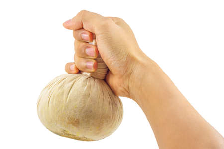 Man hand with herbal ball for spa treatment isolated on white background.の写真素材