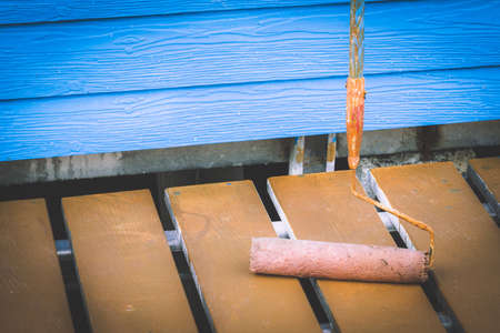 Painting of blue wall with paint rollerの写真素材