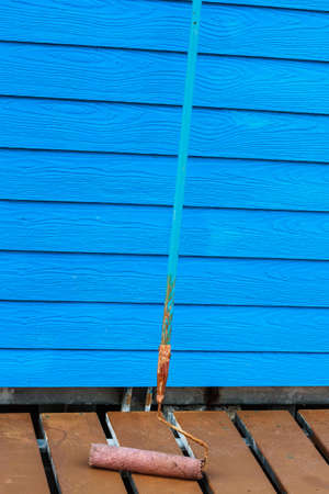Painting of blue wall with paint rollerの写真素材